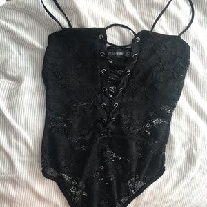 Lacy black body suit.
